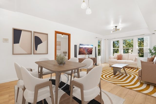 dining area featuring an inviting chandelier and light hardwood / wood-style floors