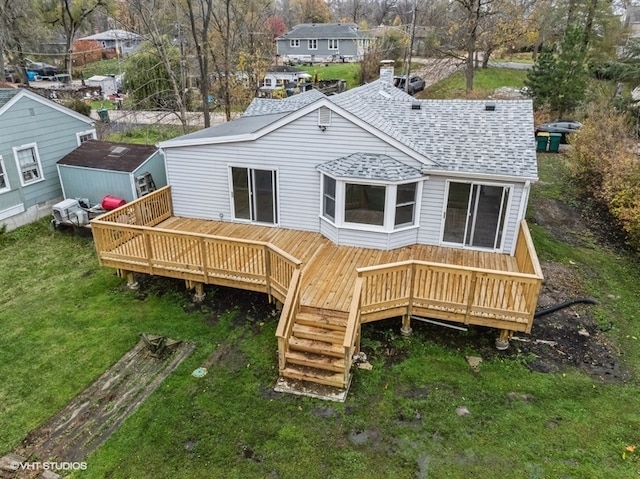 back of house with a lawn and a wooden deck