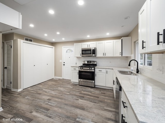 kitchen featuring white cabinetry, sink, dark hardwood / wood-style floors, and appliances with stainless steel finishes