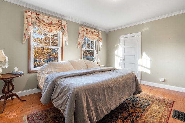 bedroom featuring hardwood / wood-style floors and ornamental molding