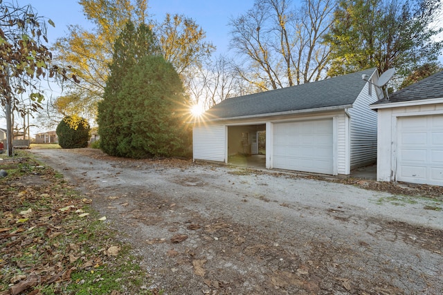 view of garage at dusk