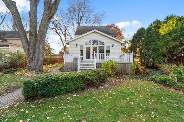 view of front of property featuring a front lawn and a wooden deck