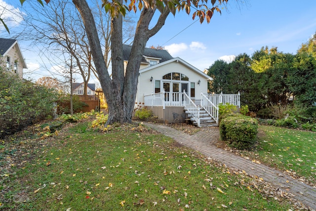 view of front of home with a front lawn and a wooden deck