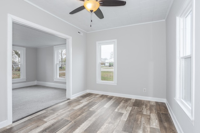 empty room with ceiling fan, crown molding, and light wood-type flooring