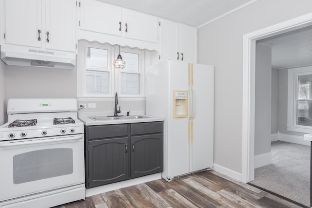 kitchen with dark hardwood / wood-style flooring, white appliances, white cabinetry, and sink