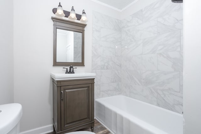 full bathroom featuring toilet, hardwood / wood-style floors, ornamental molding, and vanity