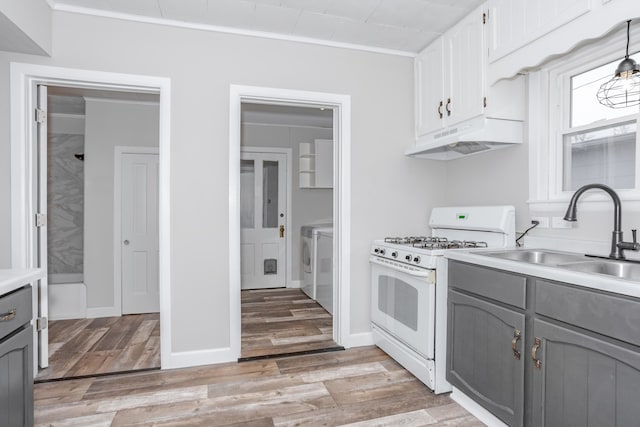 kitchen with white range with gas cooktop, white cabinetry, sink, and gray cabinets