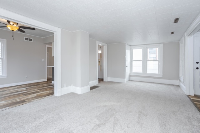 unfurnished living room featuring ceiling fan and hardwood / wood-style flooring