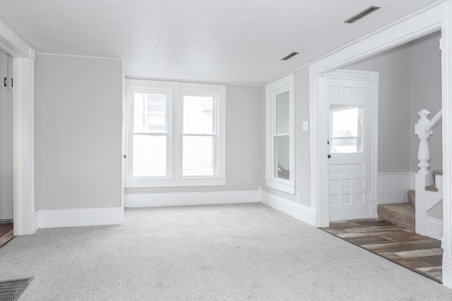 unfurnished living room featuring carpet flooring