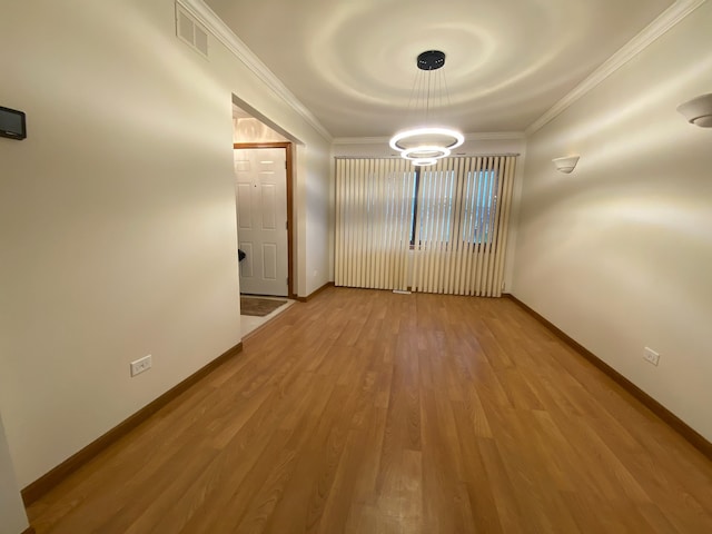 unfurnished room with light hardwood / wood-style floors and crown molding