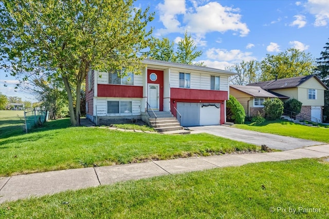 raised ranch featuring a garage and a front lawn