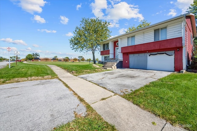 bi-level home with a garage and a front lawn