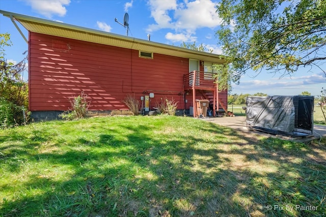 rear view of property with a lawn