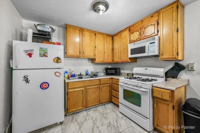 kitchen featuring sink and white appliances