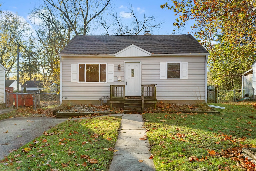 bungalow-style home with a front yard