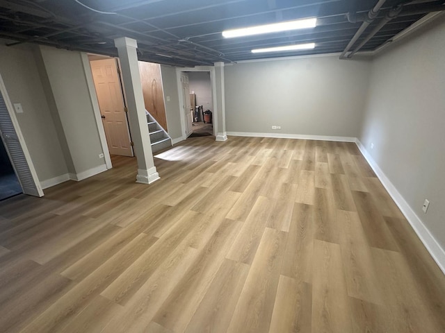 basement with light hardwood / wood-style flooring