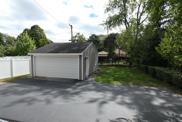 garage featuring a lawn