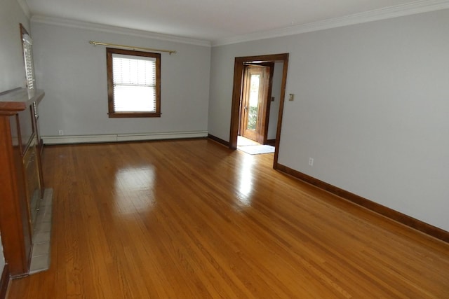 spare room with baseboard heating, crown molding, and hardwood / wood-style flooring