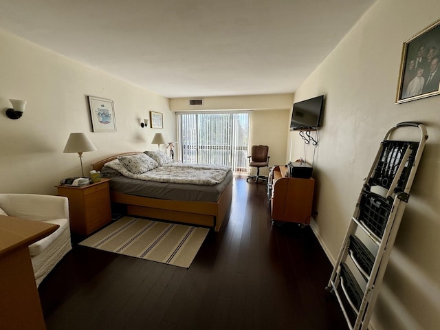 bedroom featuring dark hardwood / wood-style flooring