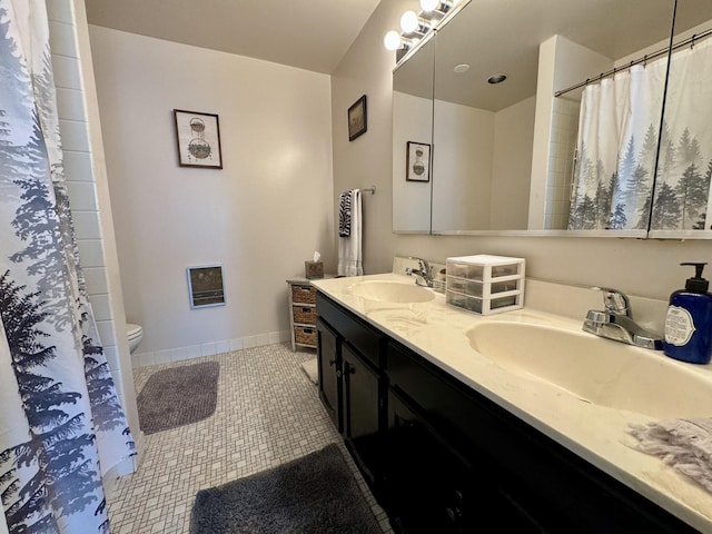 bathroom with vanity, toilet, and tile patterned flooring