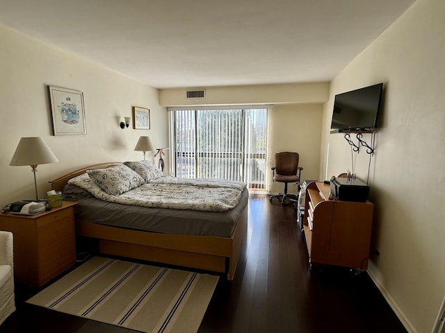 bedroom featuring dark wood-type flooring and access to exterior