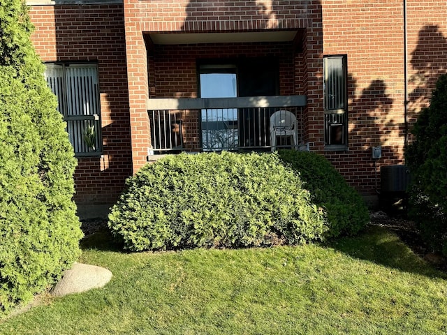 view of exterior entry with a yard