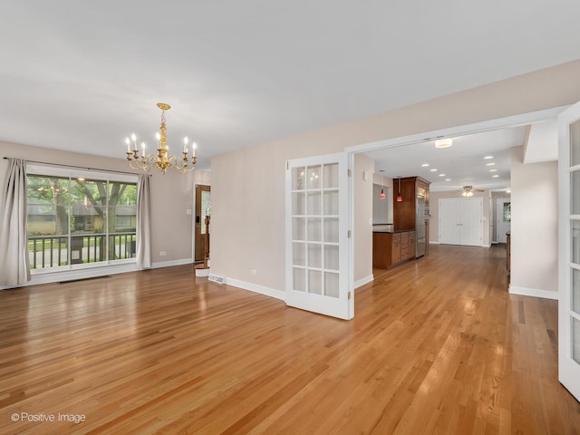 interior space with an inviting chandelier and light wood-type flooring