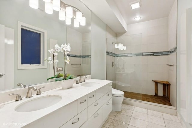 bathroom with tile patterned floors, vanity, toilet, and a shower with shower door