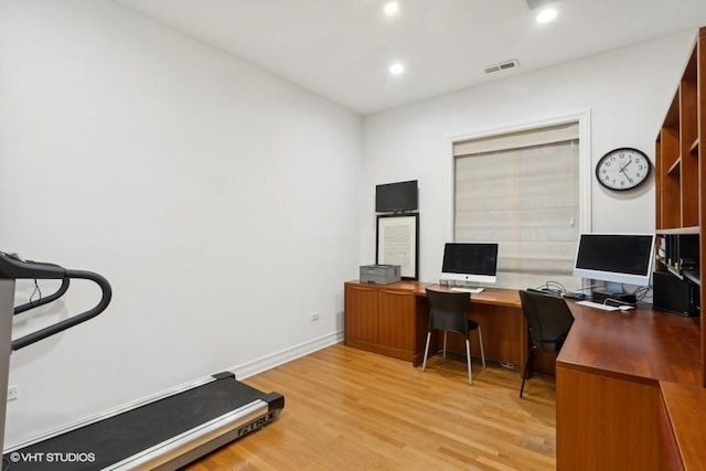 home office with light hardwood / wood-style floors