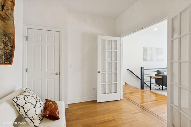 sitting room with hardwood / wood-style floors and french doors