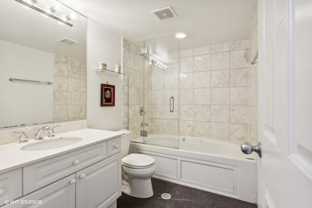 full bathroom featuring combined bath / shower with glass door, vanity, and toilet