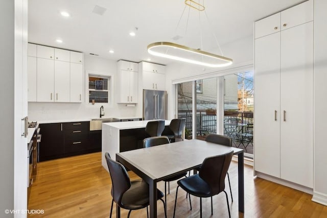 dining area with light hardwood / wood-style floors and sink