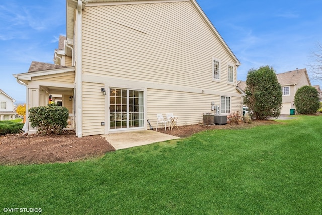 back of house featuring a yard, a patio, and central air condition unit