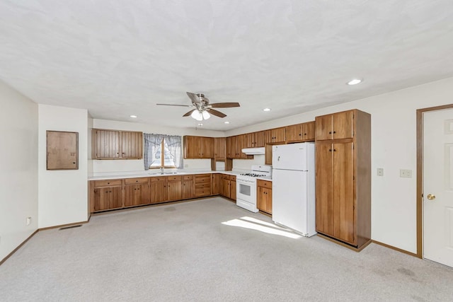 kitchen featuring white appliances, light colored carpet, ceiling fan, and sink