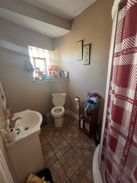 bathroom featuring toilet and vanity