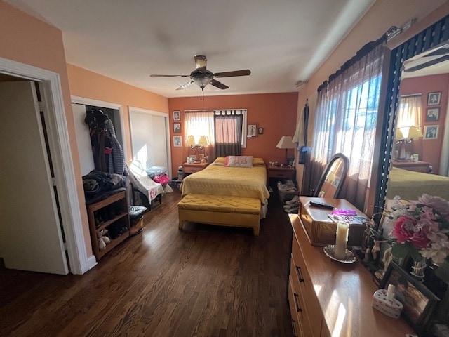 bedroom with ceiling fan, dark hardwood / wood-style floors, and a closet