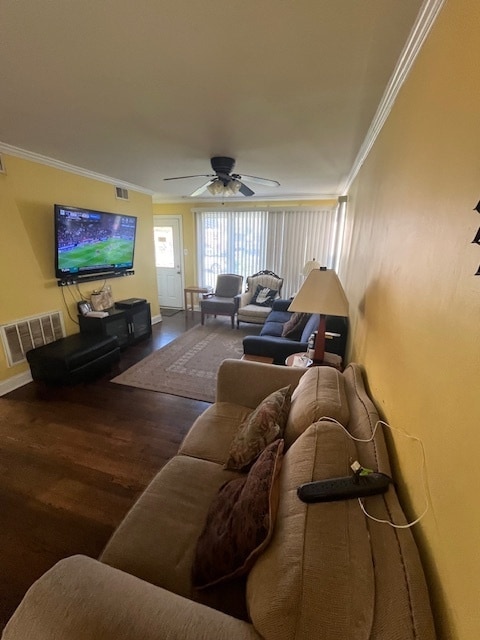 living room with hardwood / wood-style floors, ceiling fan, and crown molding