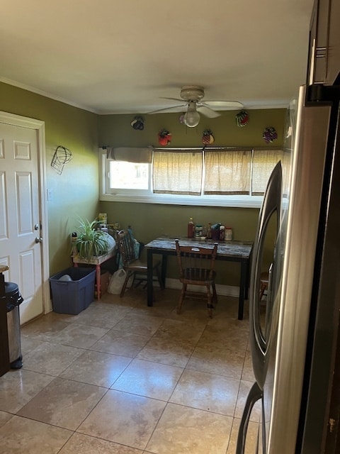 sunroom / solarium featuring ceiling fan