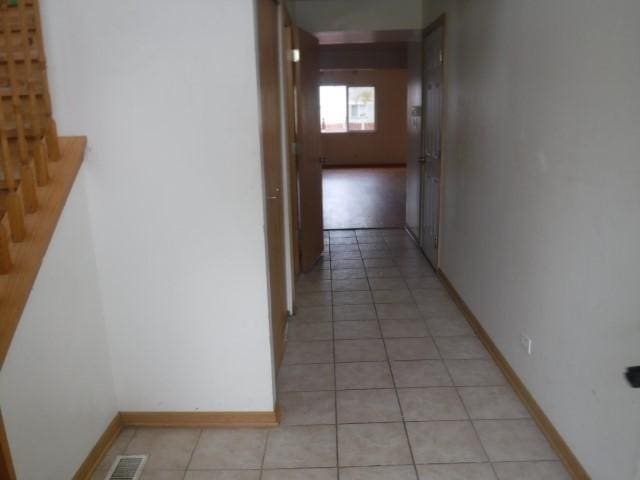 hall with light tile patterned floors