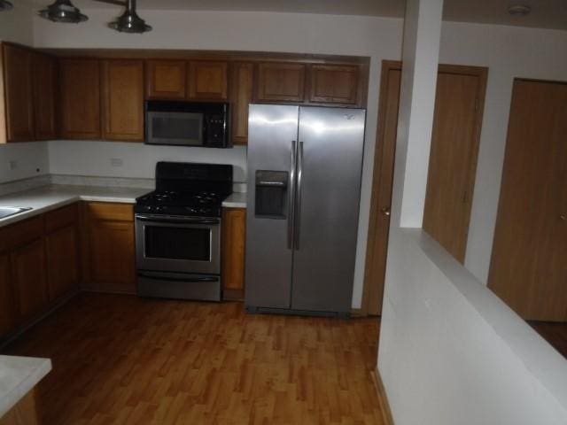 kitchen with light hardwood / wood-style flooring and stainless steel appliances