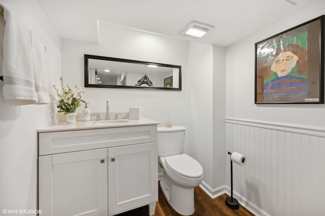 bathroom featuring hardwood / wood-style floors, vanity, and toilet