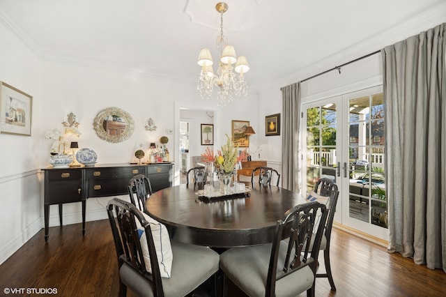 dining room featuring a chandelier, french doors, dark wood-type flooring, and ornamental molding