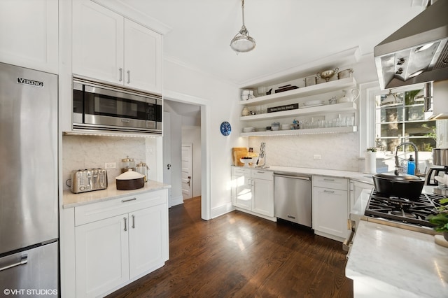 kitchen with white cabinetry, stainless steel appliances, tasteful backsplash, light stone counters, and dark hardwood / wood-style flooring