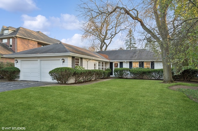 view of front of property featuring a front yard and a garage