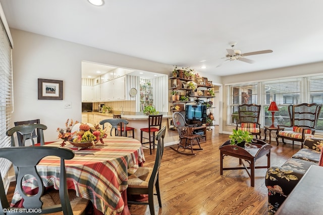 dining area with light hardwood / wood-style floors and ceiling fan