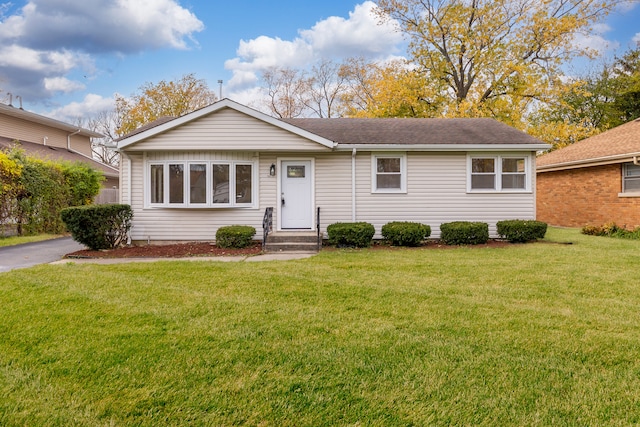 ranch-style house featuring a front lawn