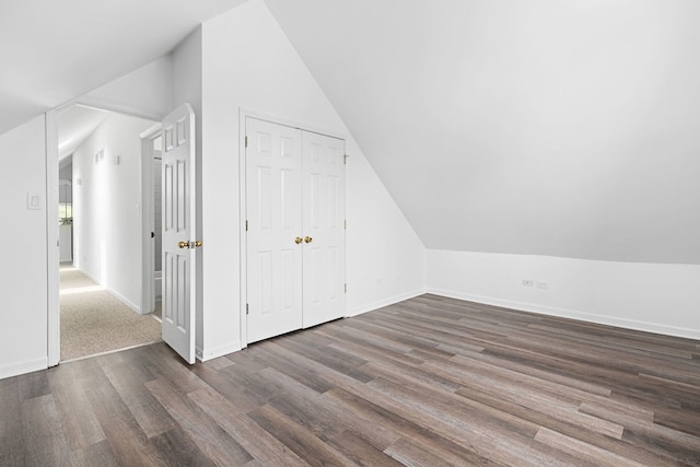 additional living space featuring dark hardwood / wood-style floors and vaulted ceiling