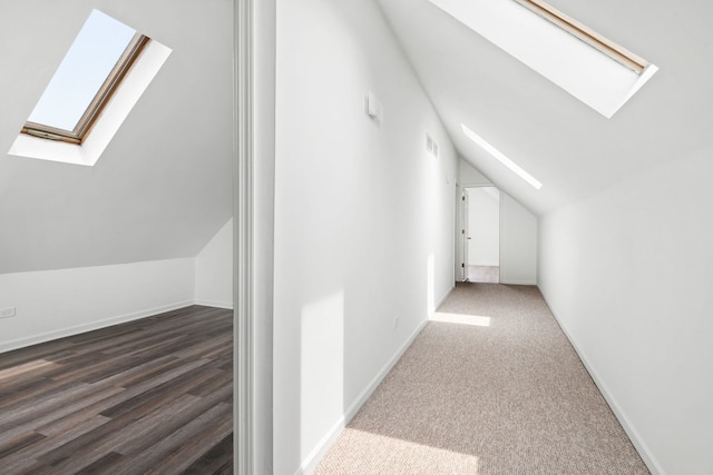 bonus room with hardwood / wood-style flooring and vaulted ceiling