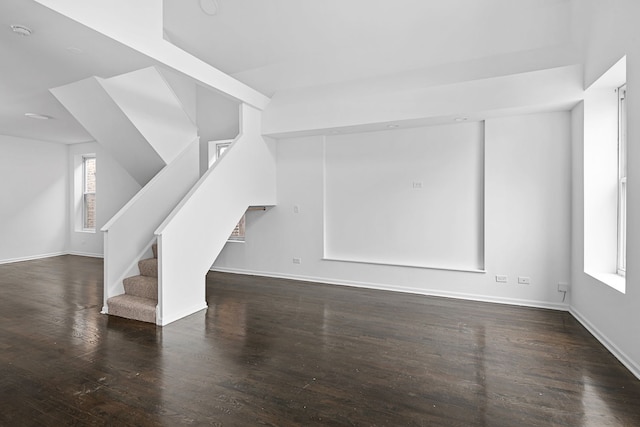 unfurnished living room with dark hardwood / wood-style floors