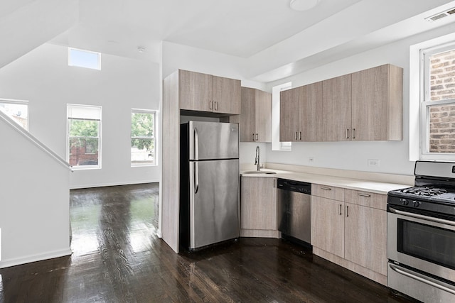 kitchen featuring light brown cabinets, dark hardwood / wood-style flooring, sink, and appliances with stainless steel finishes